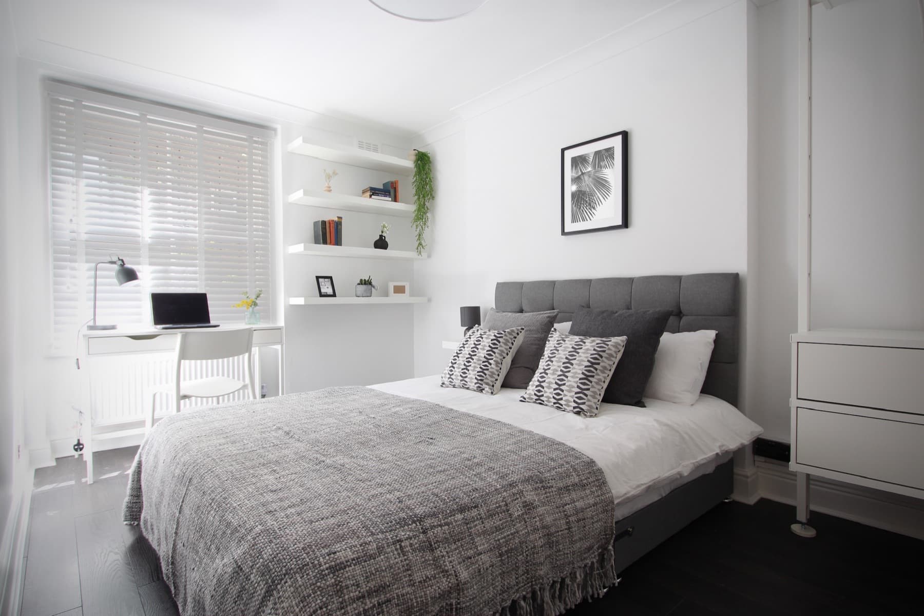 The second bedroom with its dedicated desk workspace by the window