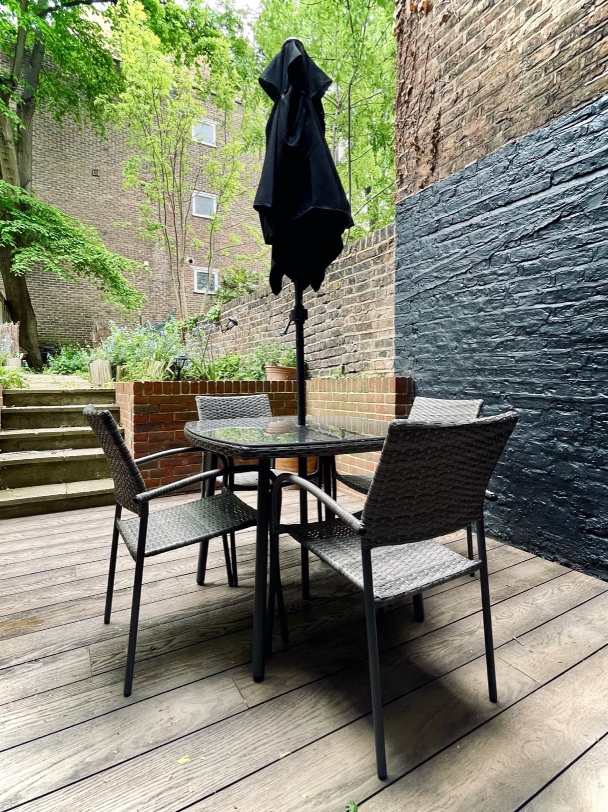 The private courtyard — outdoor dining table and chairs on decking