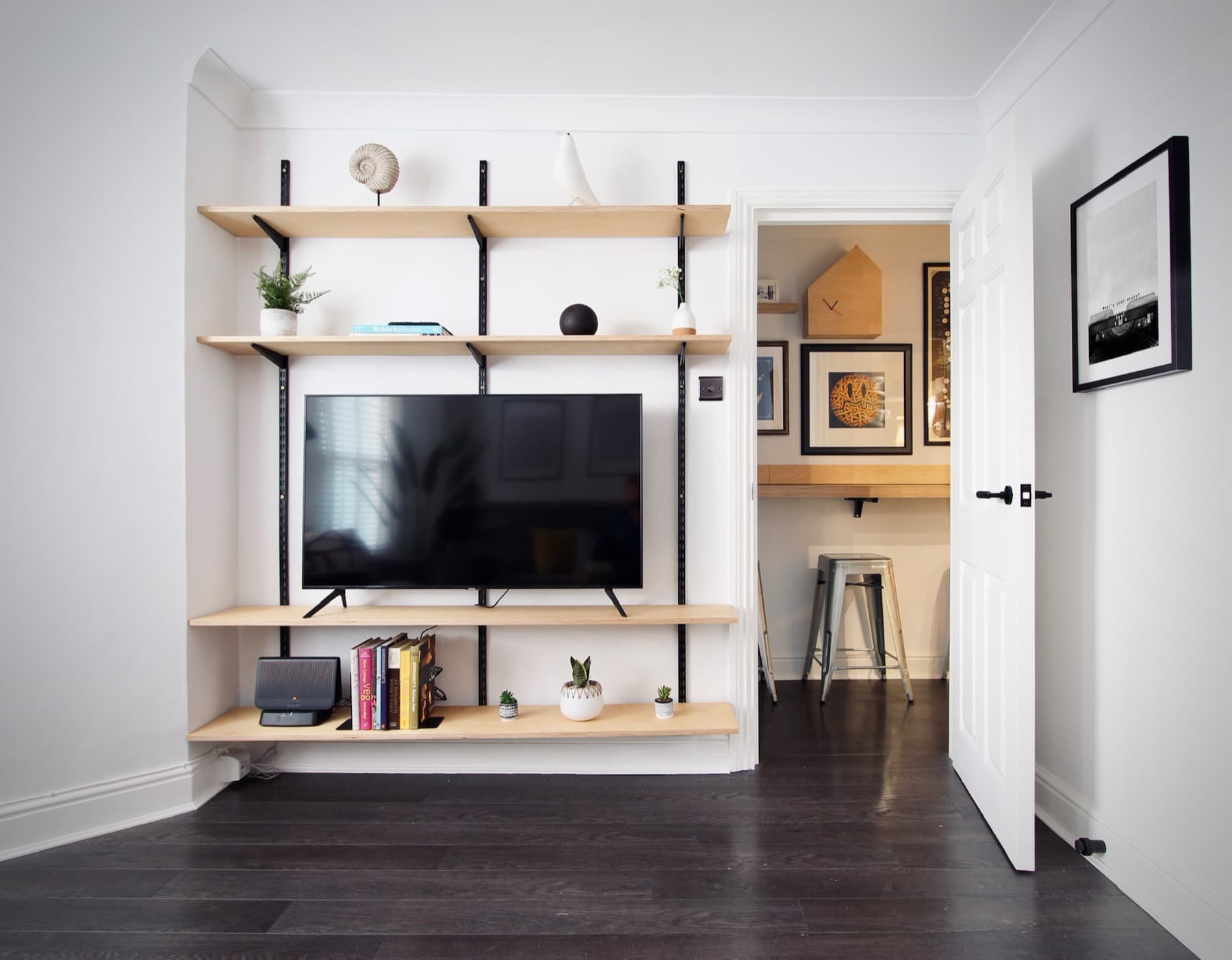 The 50-inch smart TV and open shelving in the living room
